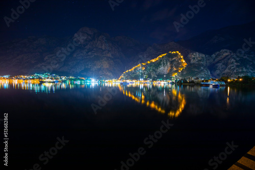 Town Kotor lights of city and reflection on a water withe the shaoe of heart during the evening, Montenegro. photo