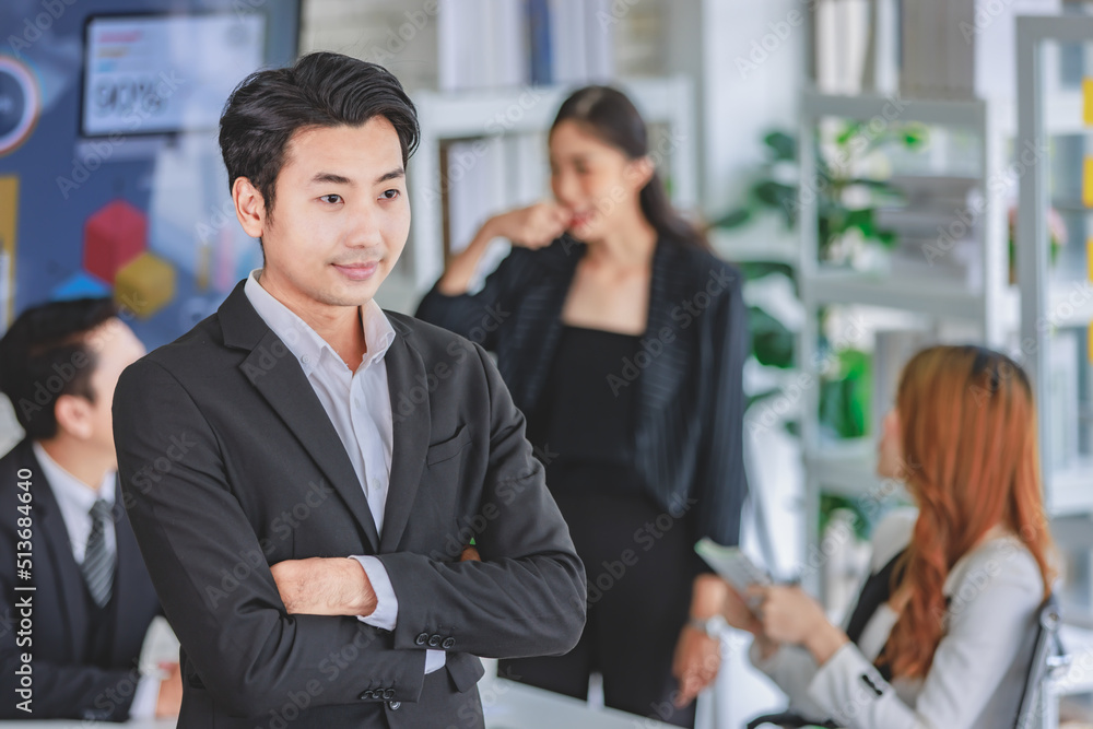 Portrait shot Asian happy cheerful smart confident millennial professional successful male businessman entrepreneur in casual blazer suit standing crossed arms smiling in company office meeting room Portrait shot Asian happy cheerful smart confident millennial professional successful male businessman entrepreneur in casual blazer suit standing crossed arms smiling in company office meeting room