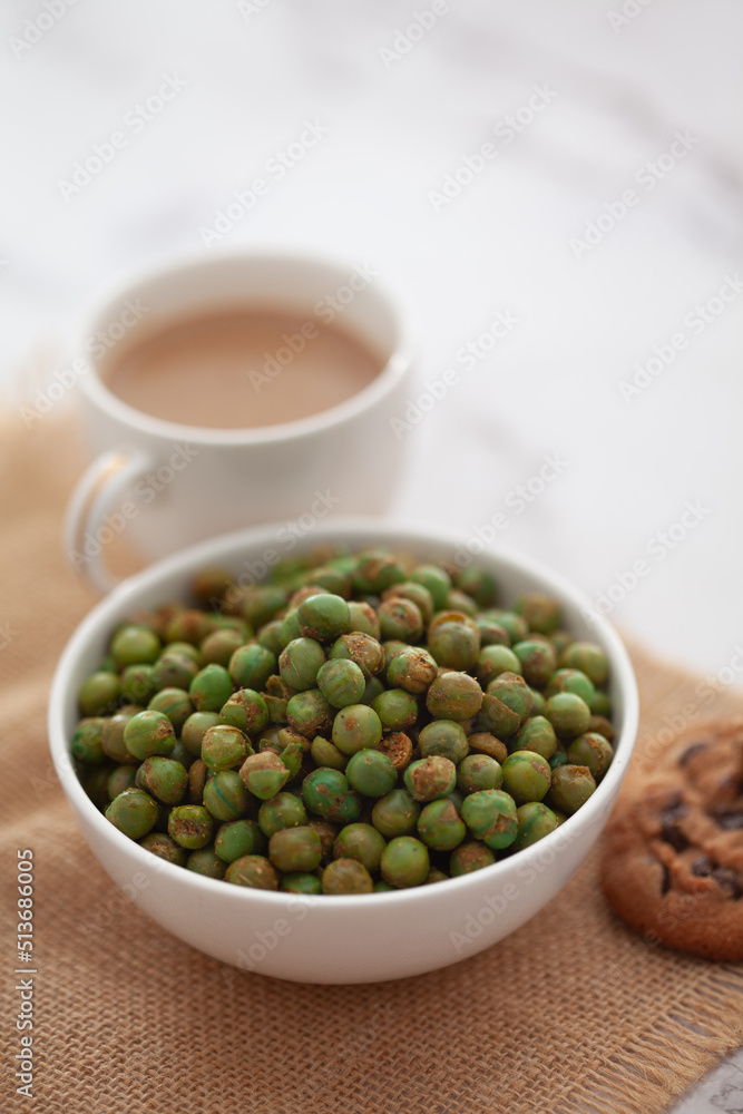 Close-Up of crunchy Indian mixture snacks with hot tea or Coffee time and handmade cookies (biscuits). Studio shoot at declined angle. Close-Up of crunchy Indian mixture snacks with hot tea or Coffee time and handmade cookies (biscuits). Studio shoot at declined angle.