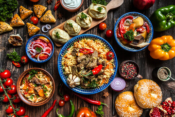 Uzbek and Central Asia cuisine concept. Assorted Uzbek food pilaf samsa lagman manti shurpa Uzbek restaurant concept Uzbek food. Food recipe background.