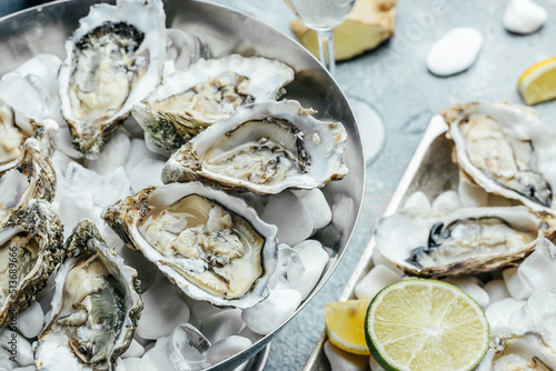Fresh Oysters with lime, lemon and ice. Restaurant menu, dieting, cookbook recipe