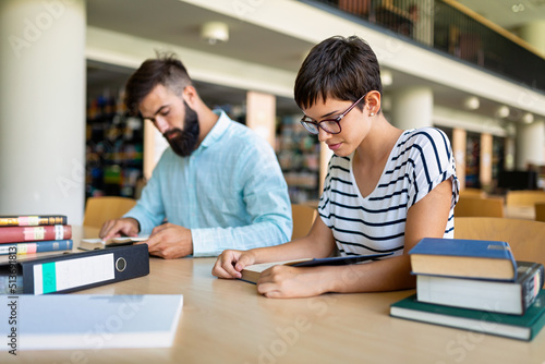 Education friendship people concept. Group of happy students learning together in college library