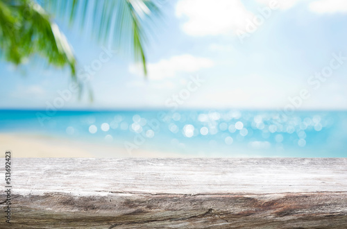 Empty wooden table on blurred tropical sea and sky background © didecs