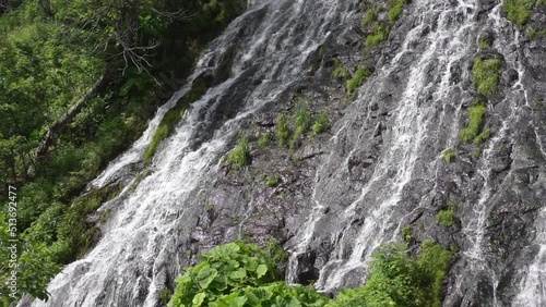 Hokkaido,Japan - June 22, 2022: Slow motion of stream at Oshinkoshin waterfall at Shiretoko, Hokkaido, Japan
 photo