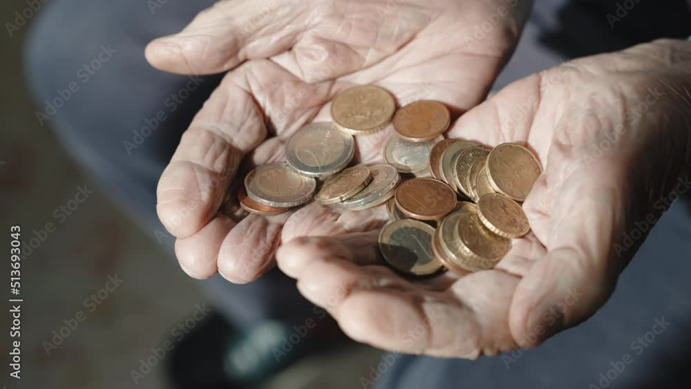 Problem of miserable budget of pensioners during world inflation, old grandfather holding coins in his wrinkled hands with despair. Poverty, low income and high expenses of senior man, poor elderly Problem of miserable budget of pensioners during world inflation, old grandfather holding coins in his wrinkled hands with despair. Poverty, low income and high expenses of senior man, poor elderly