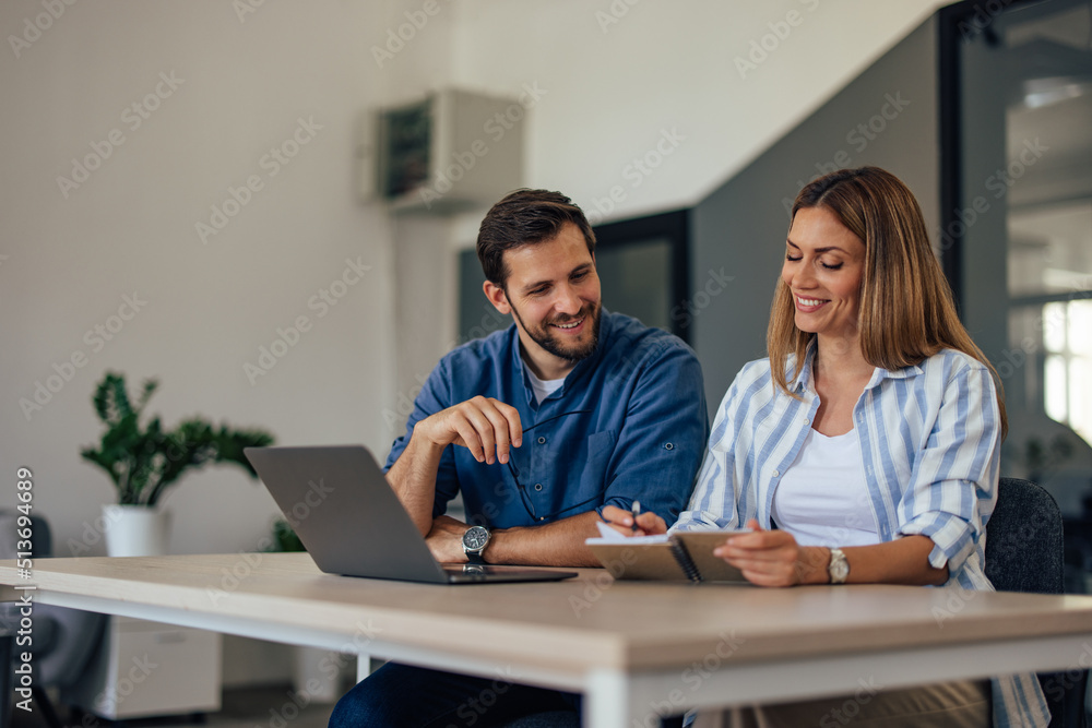 Two colleagues working together over the laptop. Two colleagues working together over the laptop.