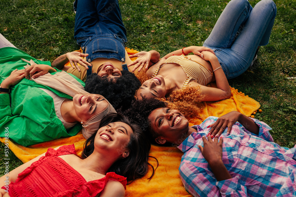 Girls lying in circle in park