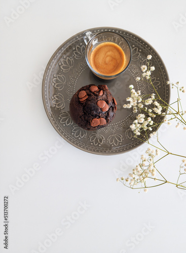 cup of coffee  chocolate  muffin on gray plate on white background