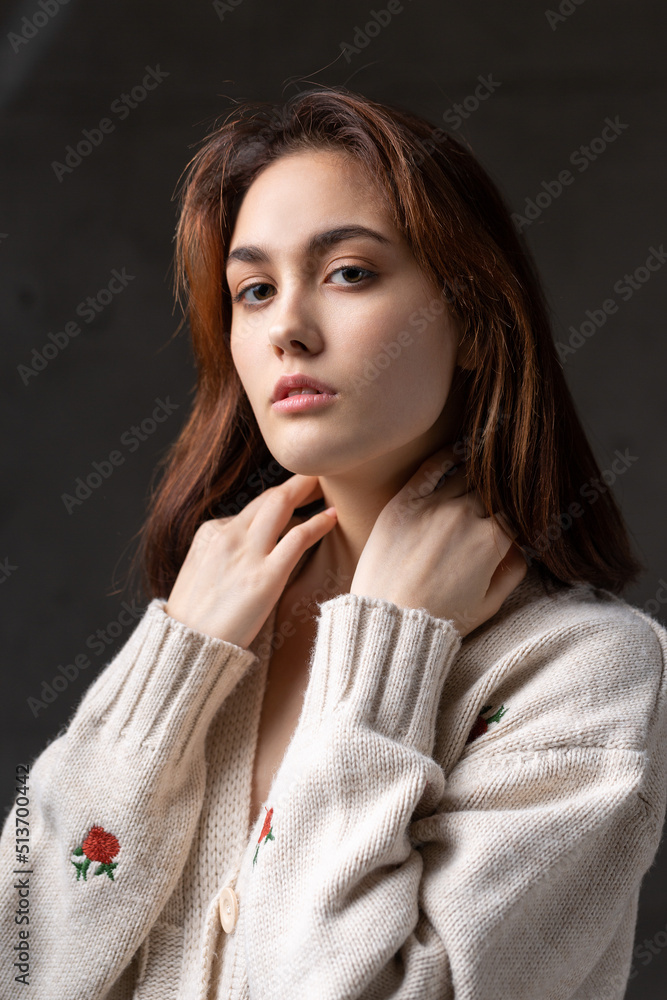 Portrait of a young brunette with long hair in the studio. Dramatic photo in dark colors. Portrait of a young brunette with long hair in the studio. Dramatic photo in dark colors.