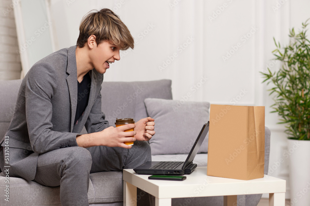 man sit on the couch and shopping in internet stores man sit on the couch and shopping in internet stores