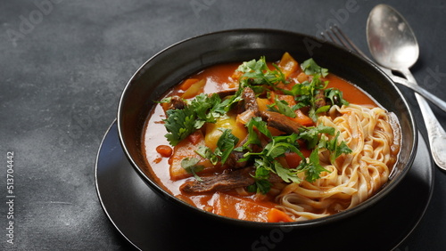 Traditional asian noodle soup with vegetables  potatoes and meat  - lagman. Oriental  uzbek style cuisine