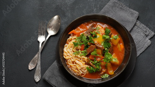 Traditional asian noodle soup with vegetables, potatoes and meat, - lagman. Oriental, uzbek style cuisine