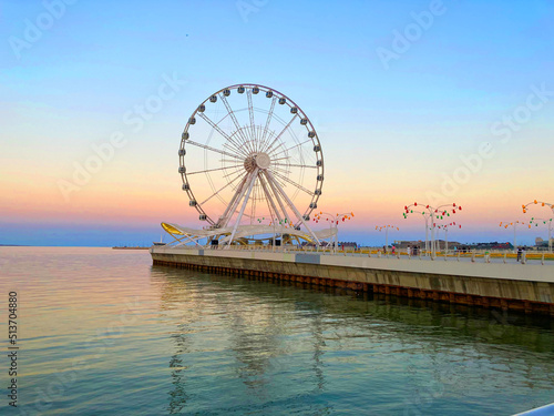 Ferris wheels in the coast of the city with beautiful weather in the evening.ferris wheel on a day. © Emil