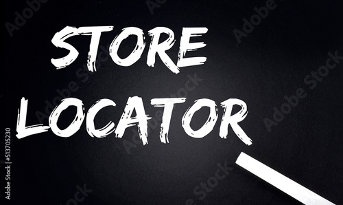 STORE LOCATOR Text on Black Chalkboard with a piece of chalk
