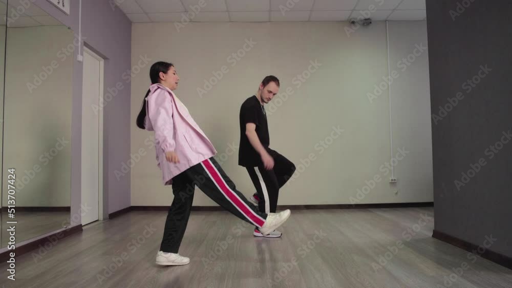 Couple of young dancers dancing hip hop in music studio. Couple of young dancers dancing hip hop in music studio.