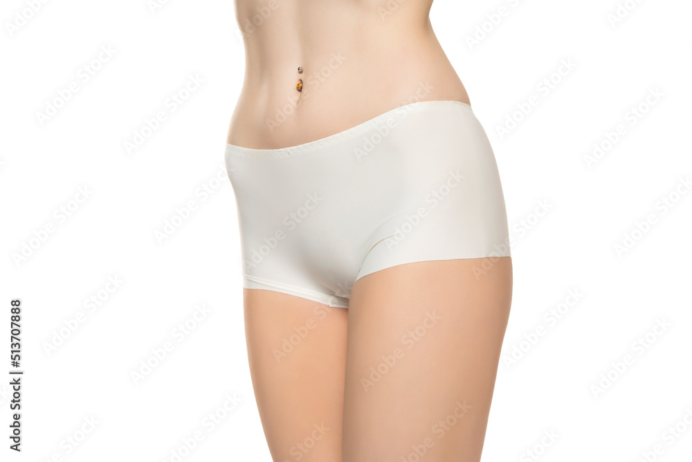 Mid section of woman wearing white briefs, front view on a white