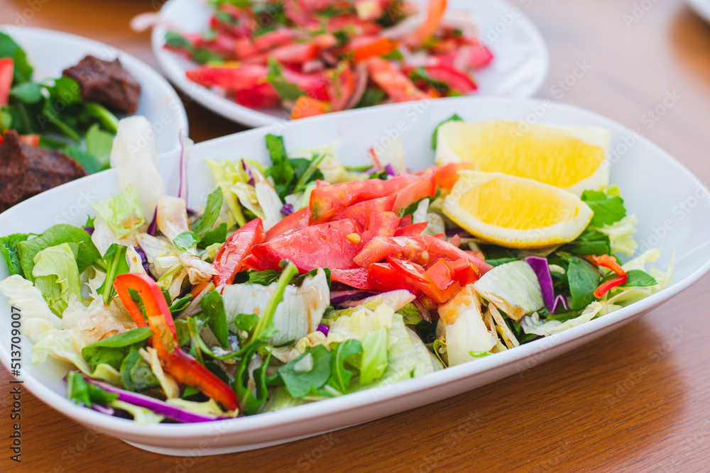 summer salad made with tomato lettuce and various vegetables