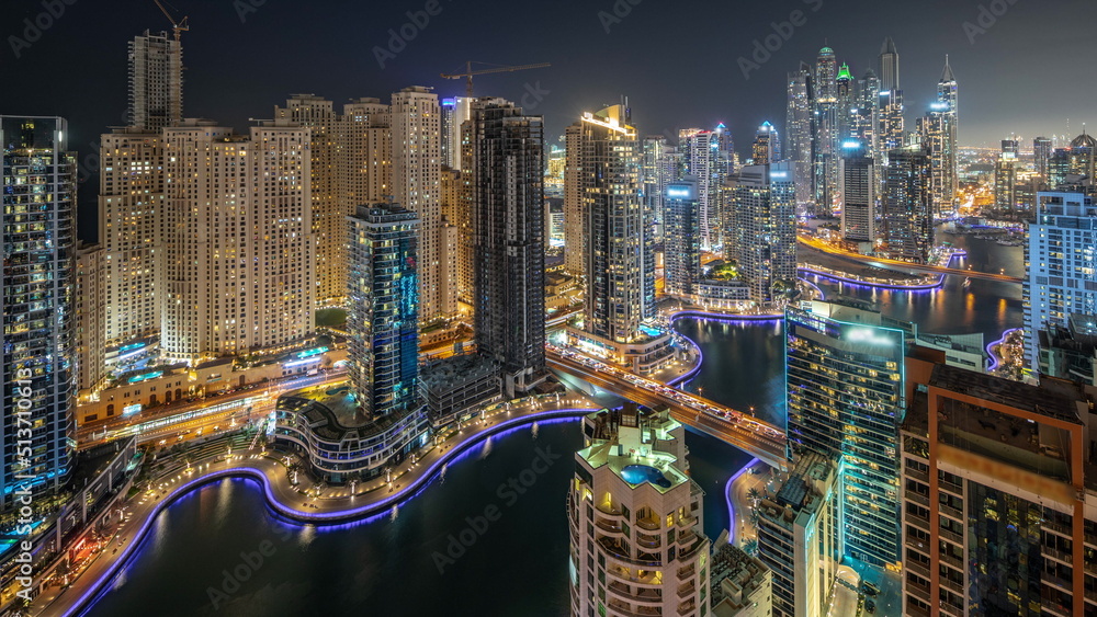 Naklejka premium View of various skyscrapers in tallest recidential block in Dubai Marina aerial night timelapse
