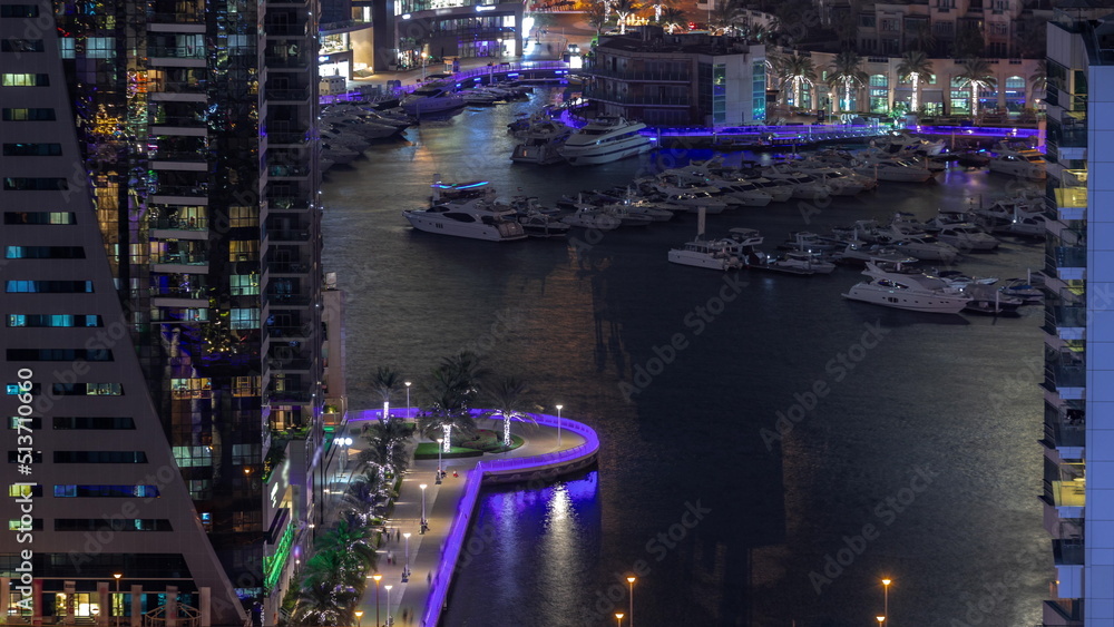 Aerial view on yachts floating in harbor night timelapse.