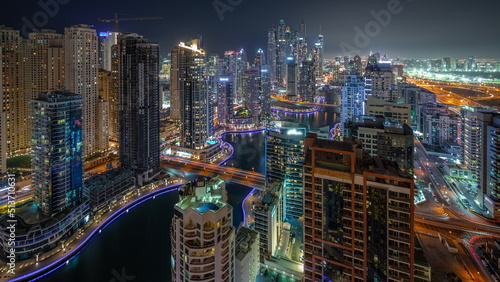 View of various skyscrapers in tallest recidential block in Dubai Marina aerial night timelapse