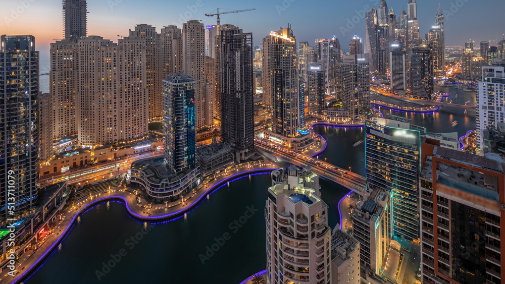 Obraz premium View of various skyscrapers in tallest recidential block in Dubai Marina aerial day to night timelapse