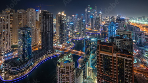 Panorama showing various skyscrapers in tallest recidential block in Dubai Marina aerial night timelapse © neiezhmakov