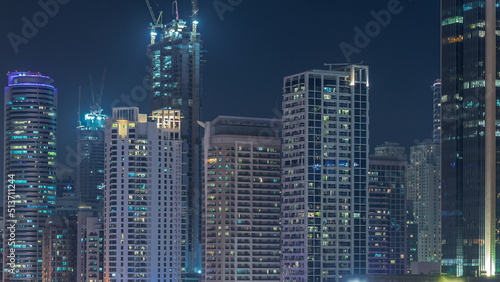 Dubai Marina skyscrapers and Sheikh Zayed road with metro railway aerial night timelapse, United Arab Emirates © neiezhmakov