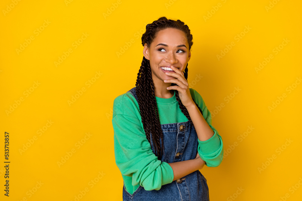 Portrait of minded pretty positive girl hand cover mouth look interested empty space isolated on yellow color background Portrait of minded pretty positive girl hand cover mouth look interested empty space isolated on yellow color background