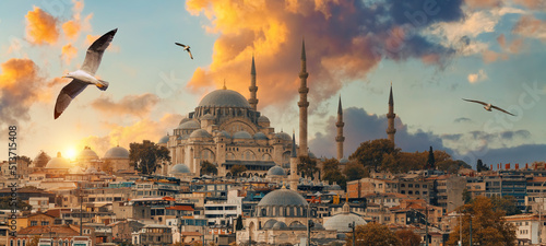 Beautiful view of gorgeous historical Suleymaniye Mosque, Rustem Pasa Mosque and buildings in front of dramatic sunset. Istanbul most popular tourism destination of Turkey. Travel Turkey concept.