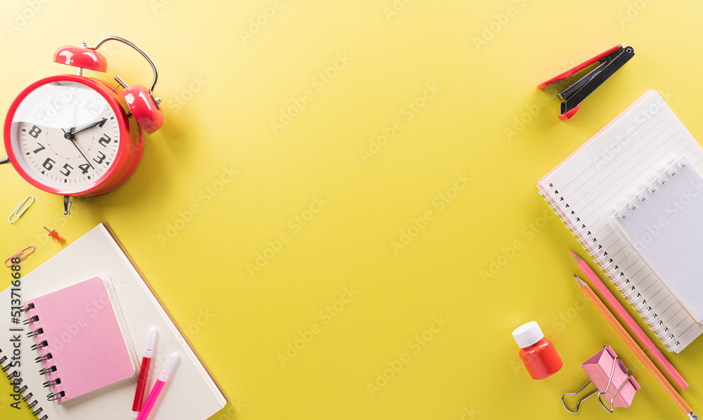 Education or back to school Concept. Top view of Colorful school supplies with books, color pencils, calculator, pen cutter clips and apple on pastel paper background. Education or back to school Concept. Top view of Colorful school supplies with books, color pencils, calculator, pen cutter clips and apple on pastel paper background.
