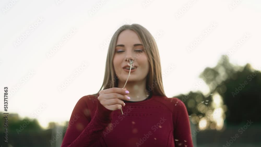 girl with dandelion. slow motion dandelion shatters into pieces girl with dandelion. slow motion dandelion shatters into pieces