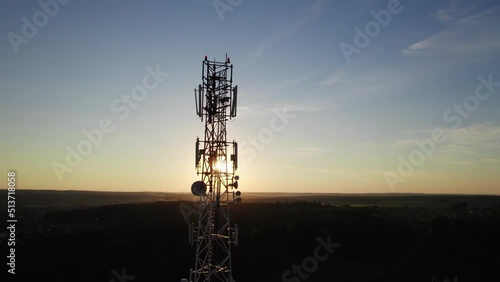 Aerial view of the telecommunications tower against the evening sky. Wireless Communication Antenna Transmitter. Cell phone, radio of cellular 5g 4g signal.	
