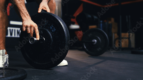 Close up of athlete pre-workout preparing barbells for working out weightlifting training in the fitness gym healthy lifestyle bodybuilding, Athlete builder muscles.