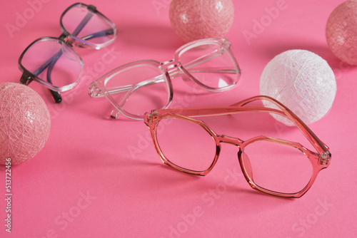 eyeglasses on bright pink background, trendy eyeglass frames copy space photo