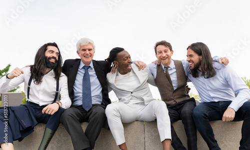 smiling multiracial coworkers hugging