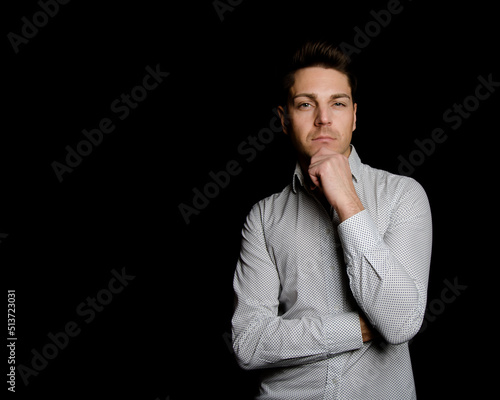 Business and work. Young attractive man. Black background. © vladorlov