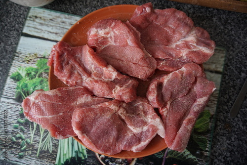 Fresh pork shoudlers on plate photo