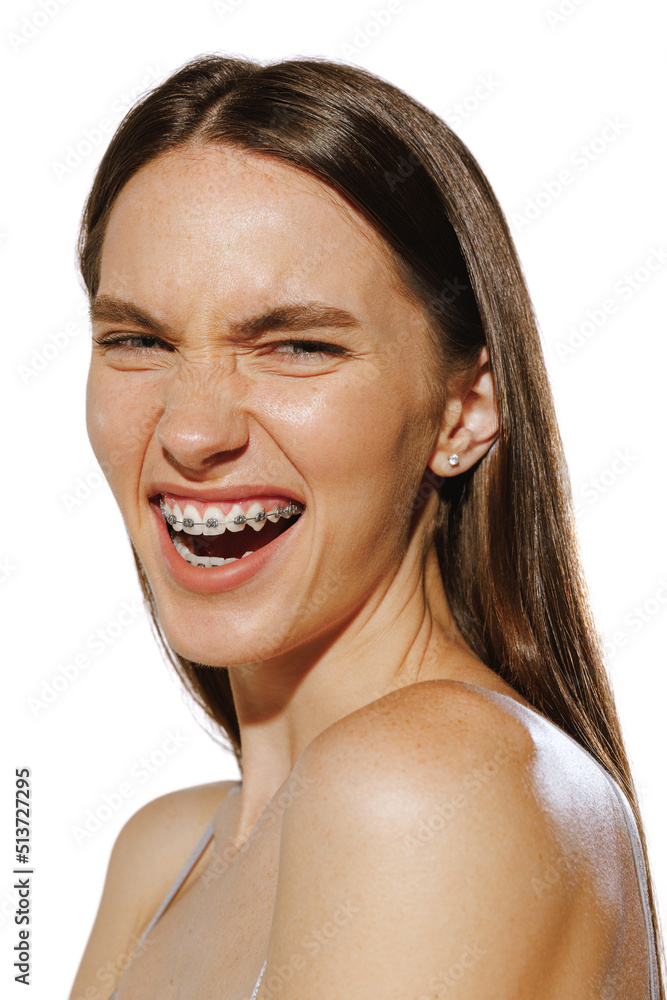 Portrait of beautiful young girl with braces. smiling, posing isolated over white background. Portrait of beautiful young girl with braces. smiling, posing isolated over white background.