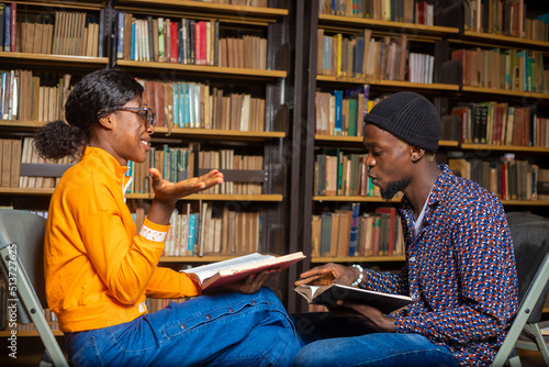 Portrait of smiling students at work in a library