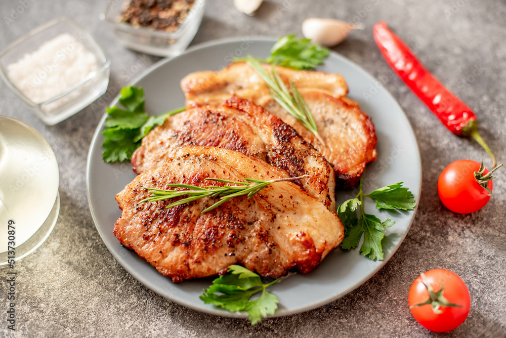 grilled pork steaks with spices on stone background grilled pork steaks with spices on stone background