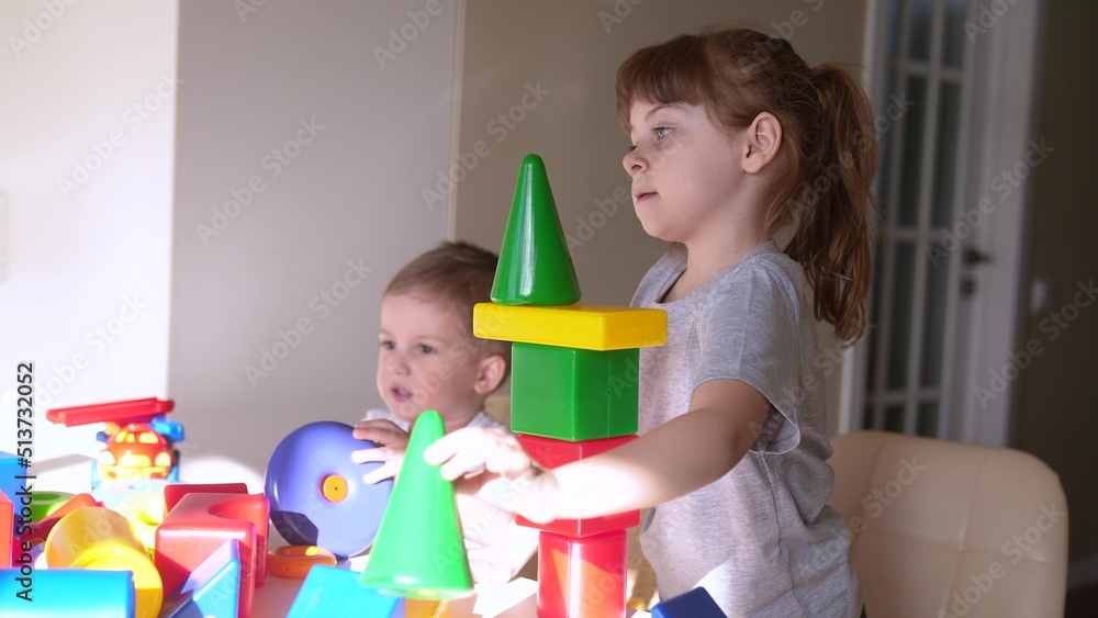 kids girl and baby play in kindergarten. a group of children play toys cubes and cars on the table in kindergarten. happy family preschool education concept. nursery baby indoor toddler home kids girl and baby play in kindergarten. a group of children play toys cubes and cars on the table in kindergarten. happy family preschool education concept. nursery baby indoor toddler home