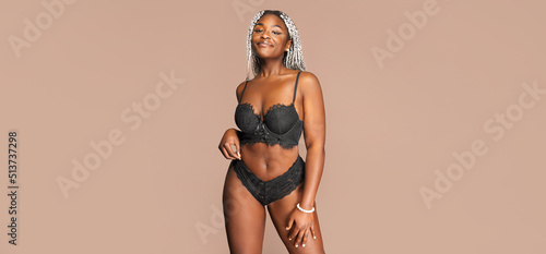 authentic body positive female smiling afro-american woman with an authentic figure