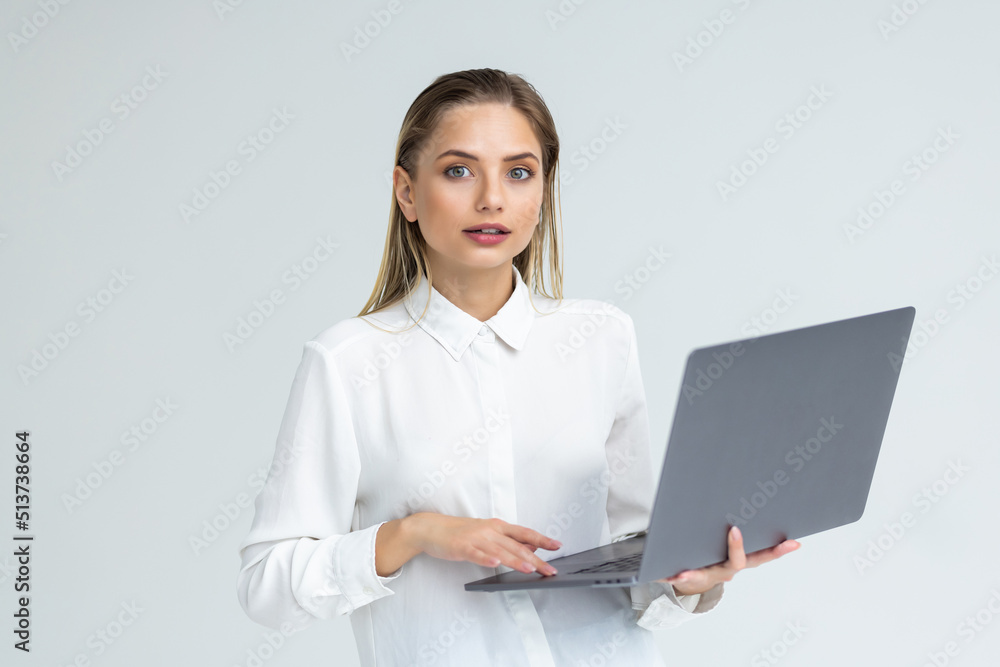 Happy woman using laptop in casual attire isolated in white background Happy woman using laptop in casual attire isolated in white background