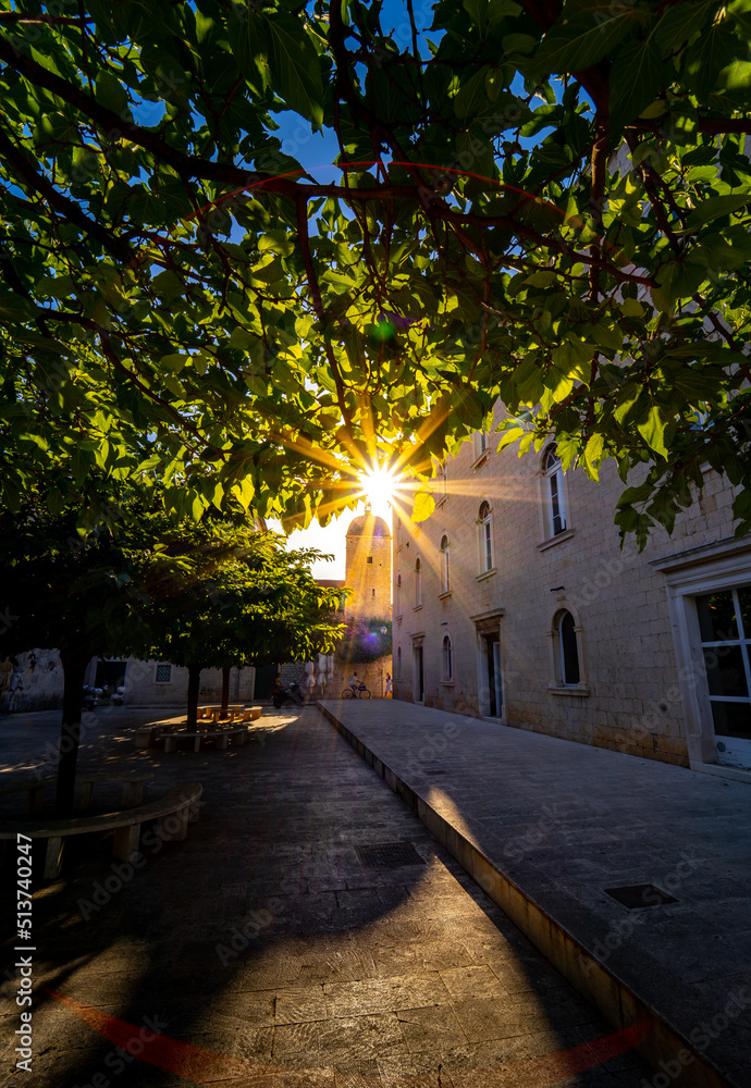 street of Croatian city Trogir with sun star in the tree
