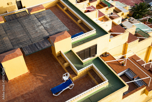 blue sunbed on yellow rooftop