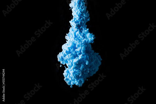 Blue paint clouds in water isolated on solid black background. Acrylic colors and ink in water. Abstract background. Isolated. Bright colorful art. Copy space for banner, poster design.