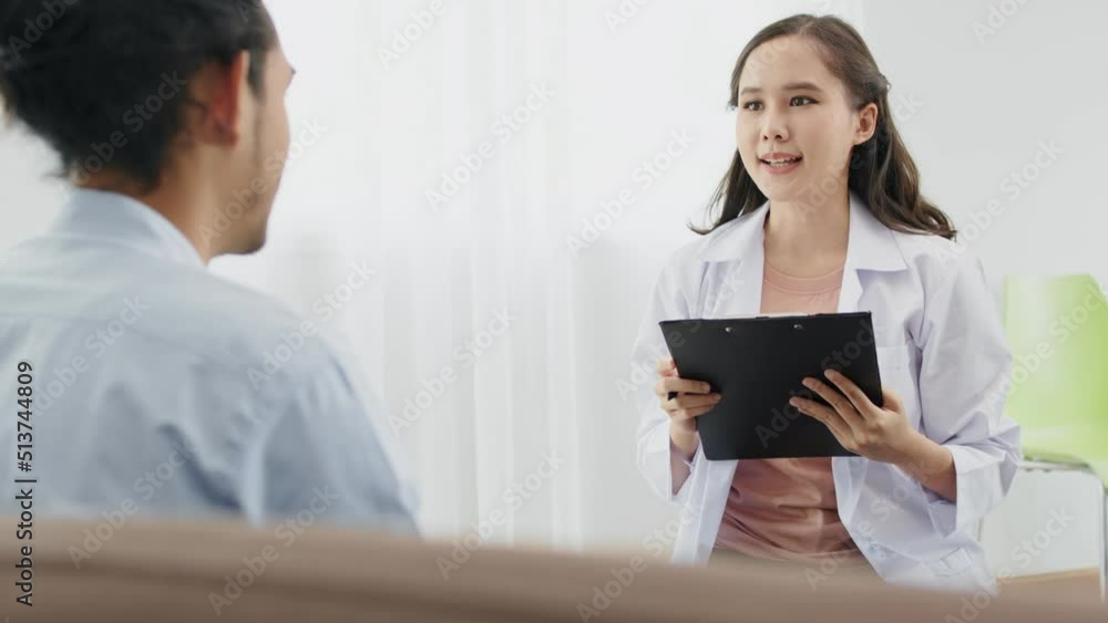 psychiatrist Asian woman counseling with male patients and note symptoms on note paper psychiatrist Asian woman counseling with male patients and note symptoms on note paper