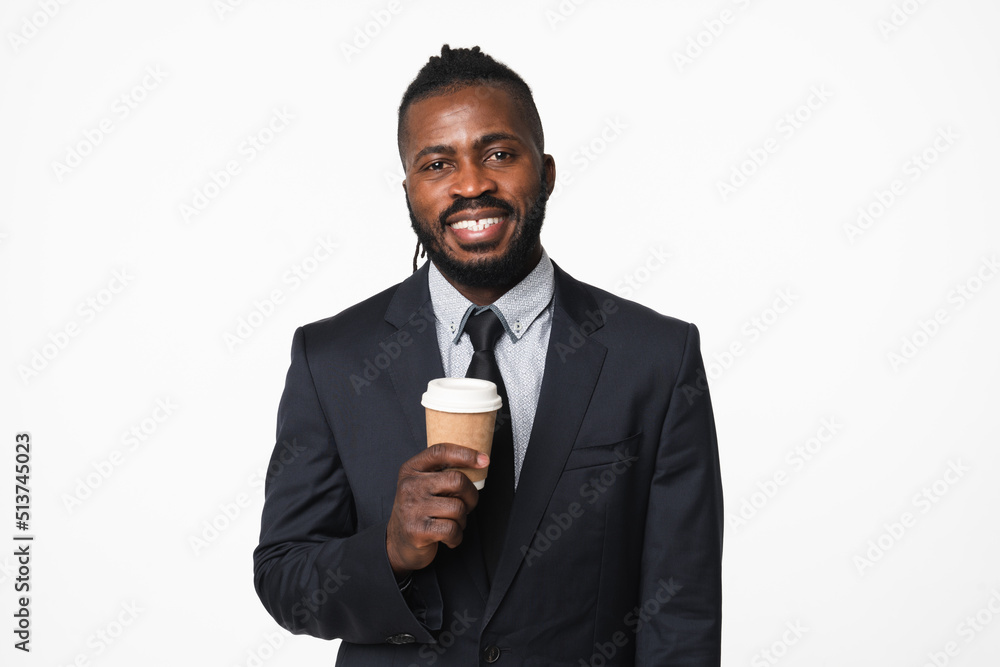 Smiling successful african-american young businessman ceo boss leader freelancer drinking coffee hot beverage in formal suit isolated in white background Smiling successful african-american young businessman ceo boss leader freelancer drinking coffee hot beverage in formal suit isolated in white background