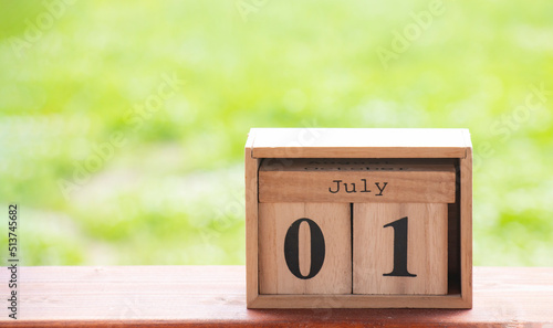 Wooden calendar July 01 on a green background ,green nature