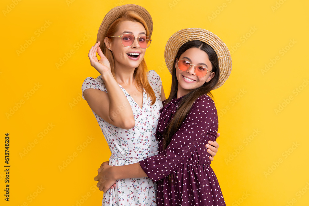 glad mother and daughter in straw hat on yellow background glad mother and daughter in straw hat on yellow background